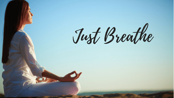 Just breathe. Woman meditates in open air.